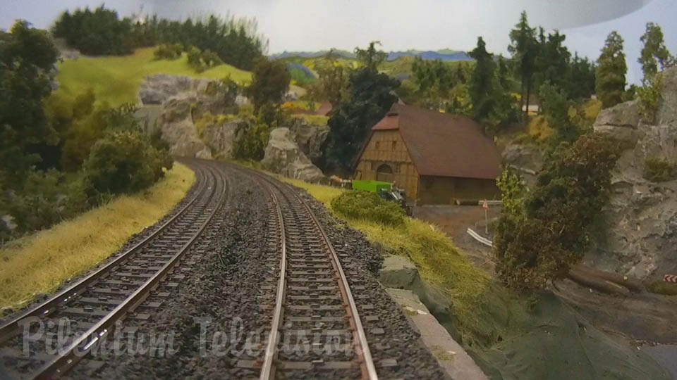 Cab ride on a model railroad layout with hidden railway station in HO scale