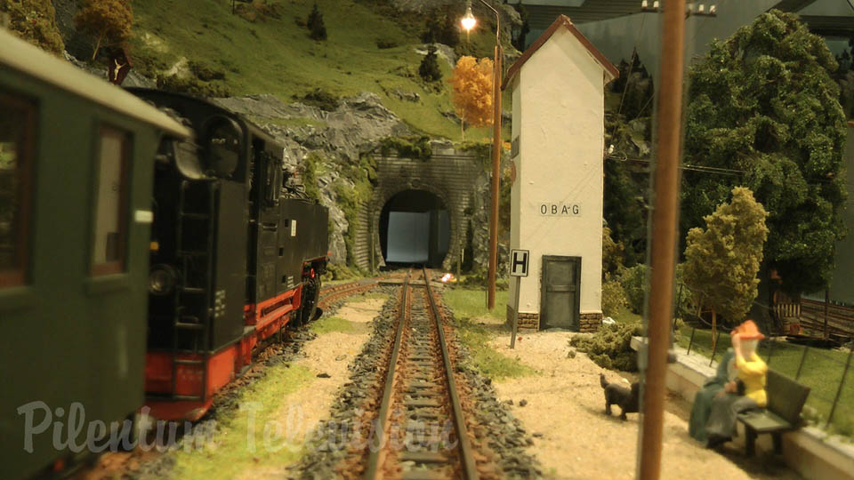 Cab ride on a mountain model railway layout with tunnel and track spiral