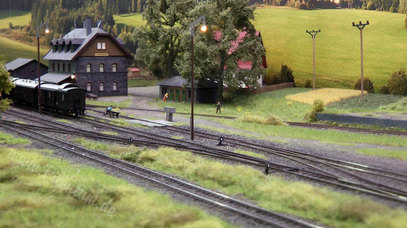 Model railway with station and very realistic landscape in HO scale