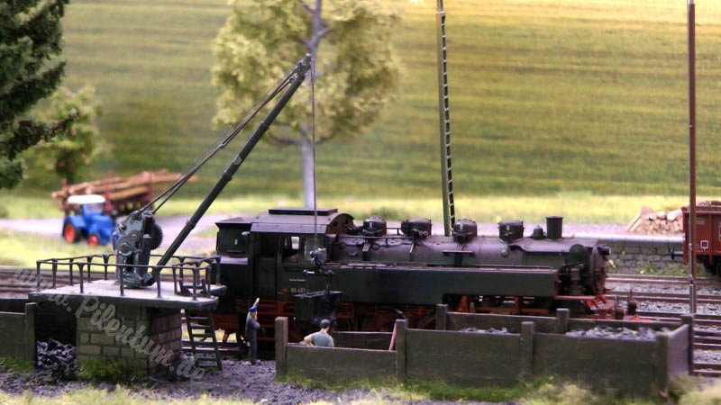 Model railway with station and very realistic landscape in HO scale