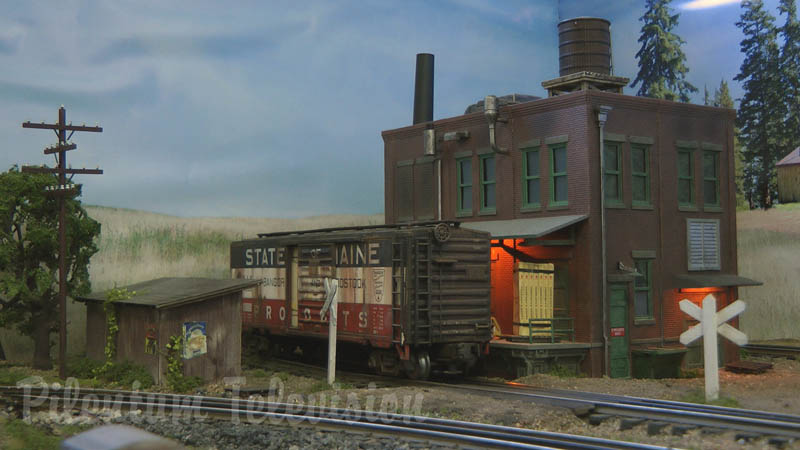 Weathering model trains on a three rail model railroad layout in O scale