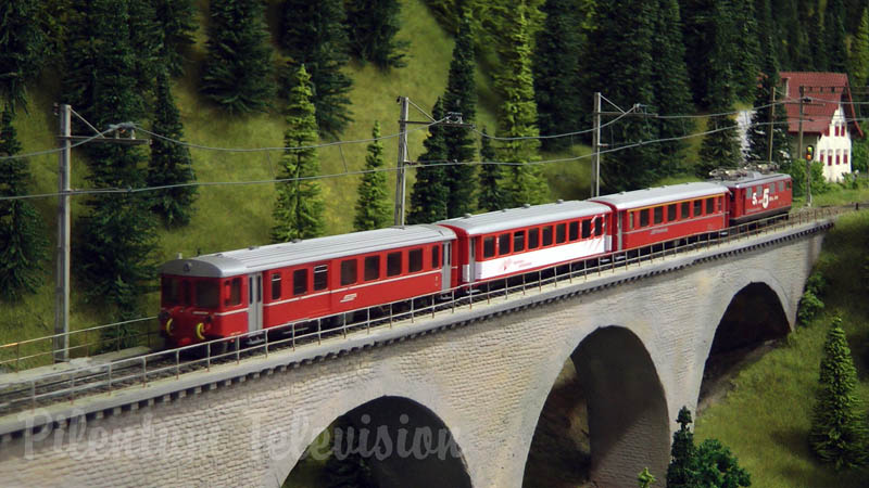 Model trains from Switzerland crossing the railroad bridge HOn3½